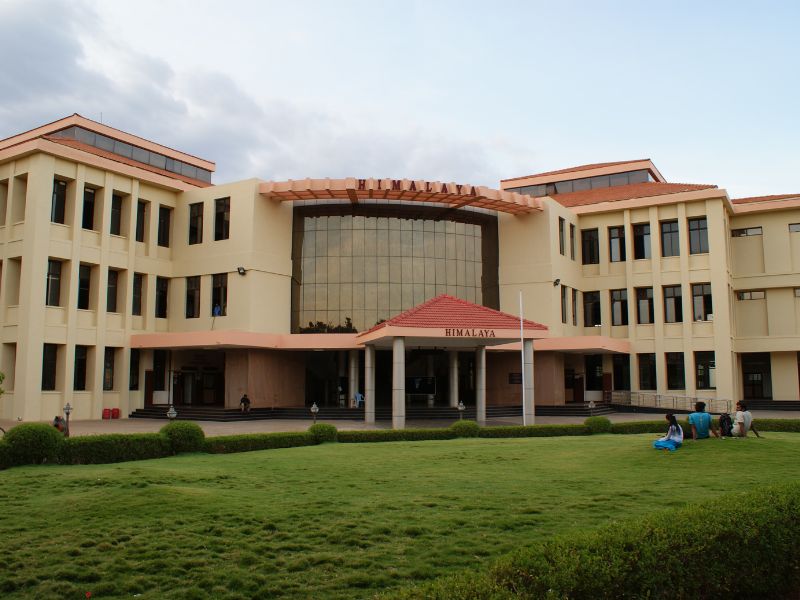Himalaya Building at IIT Madras campus with green lawn and student sitting area