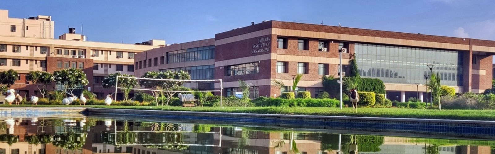 Main academic block and red-brick architecture of Jaipuria Institute of Management, Jaipur campus.